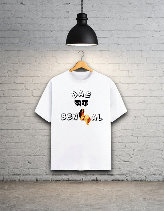 White t-shirt written 'Bae of Bengal' graphics on a hanger against a brick wall.