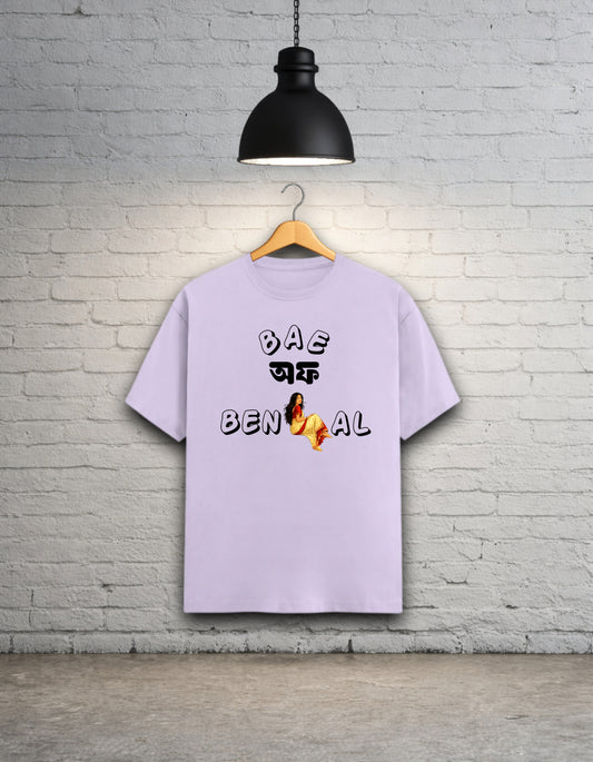 Lavender t-shirt written 'Bae of Bengal' graphics on a hanger against a brick wall.