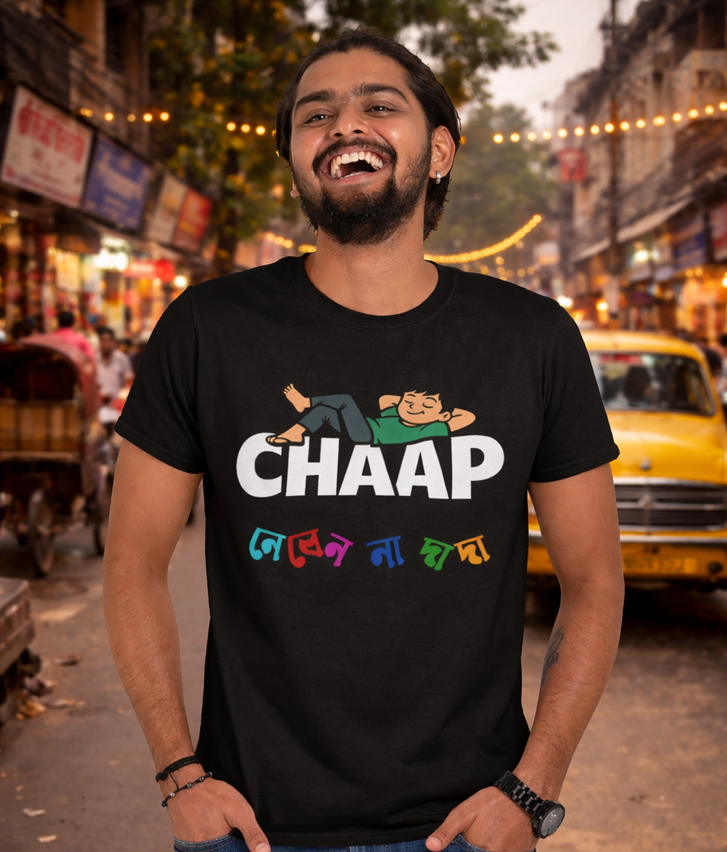 Man wearing a black t-shirt with 'CHAAP nebenna dada' bengali graphics printed on it, standing on a street.